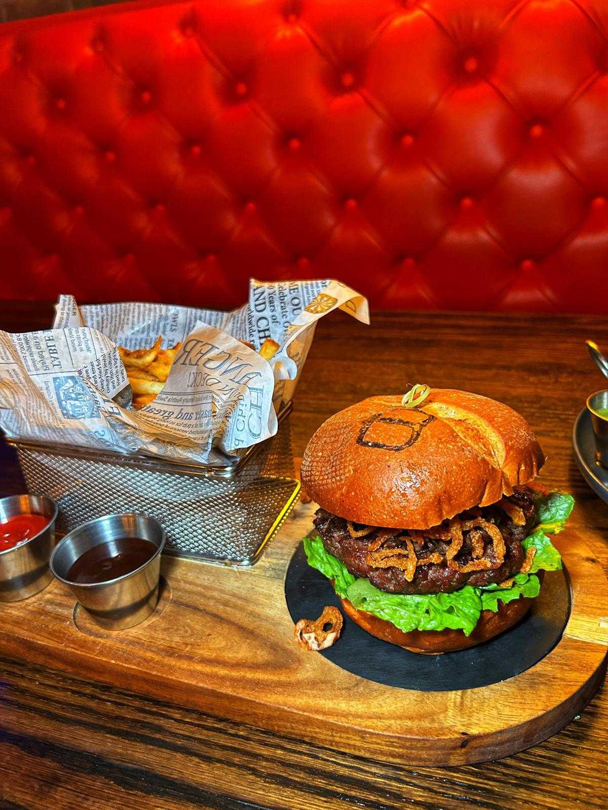 Burger and fries against the red banquette