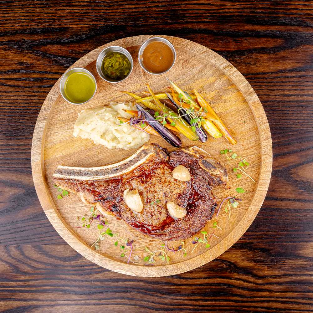 Bone-in rib steak with whipped potatoes and heirloom carrots