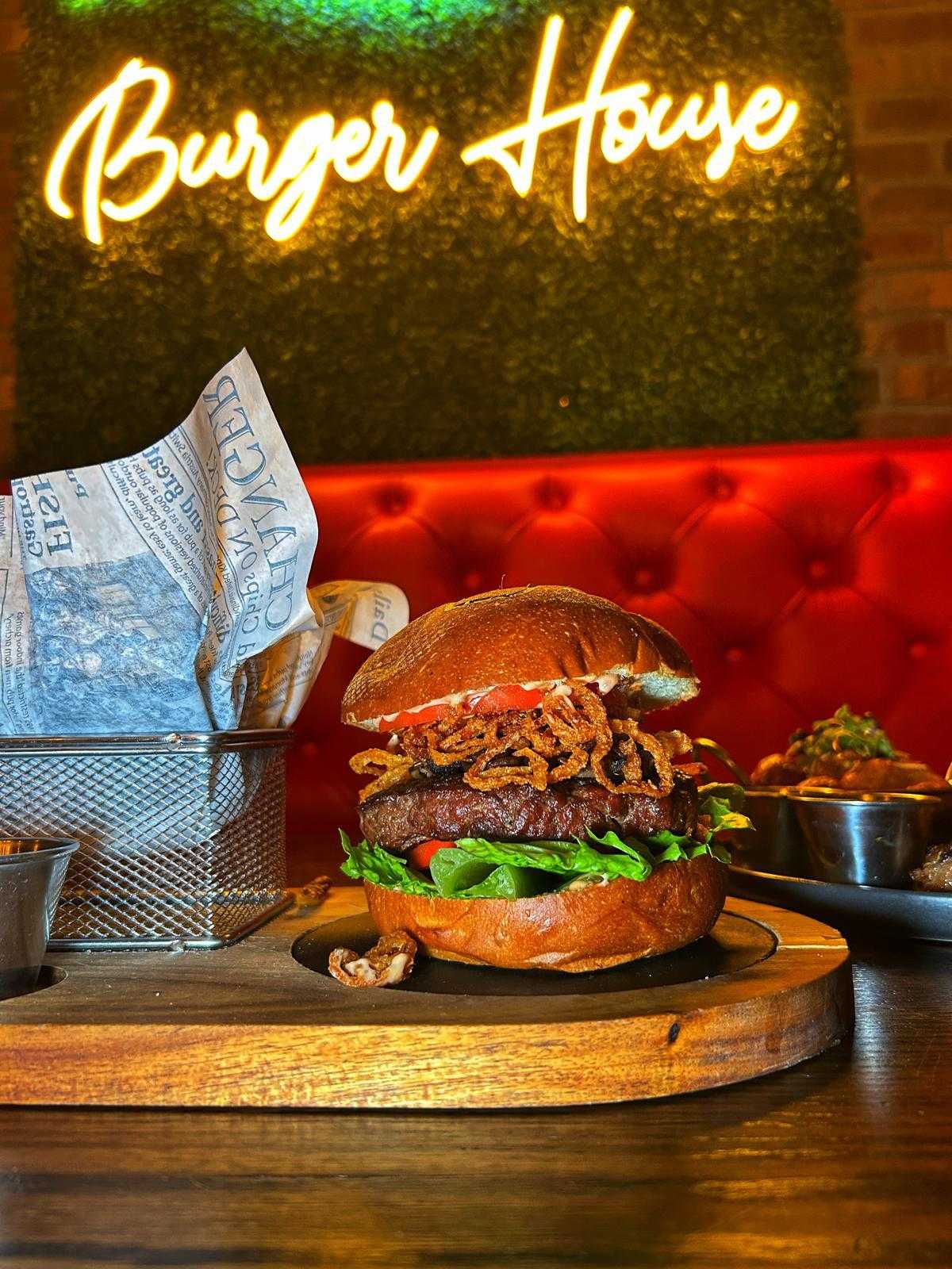 Burger under the Burger House neon sign