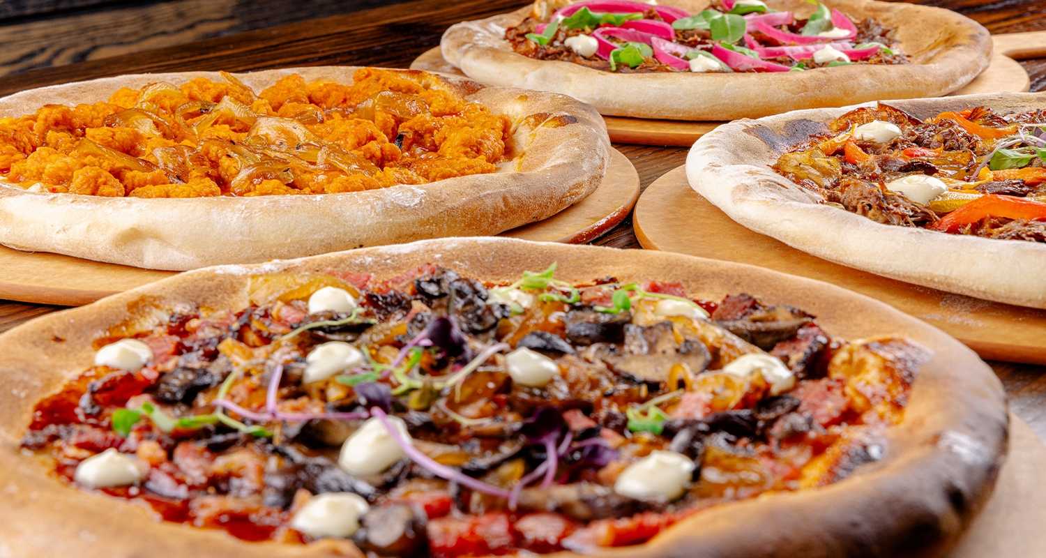 An array of meat pizzas